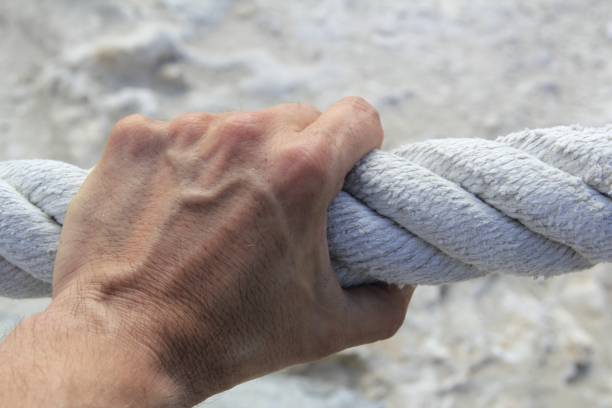 istock man hand grab grip strong big aged rope 1336895174