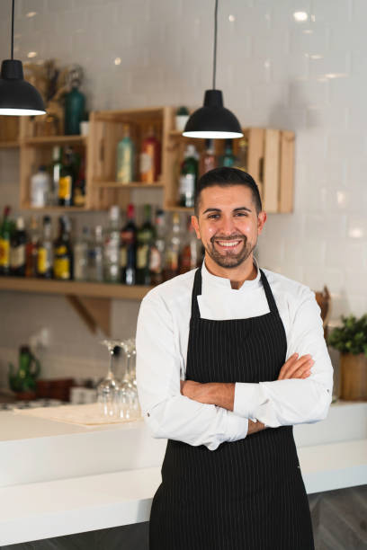 istock Chef posing wearing uniform and apron in restaurant. 1336896421