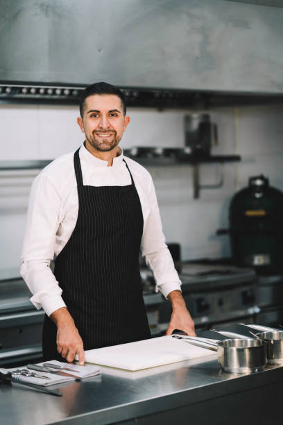 istock Chef posing wearing uniform and apron  in restaurant kitchen 1336896600