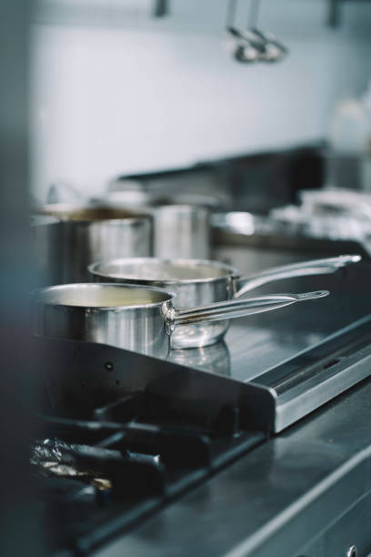istock stainless steel saucepans cooking ingredients on professional kitchen hobs 1336896802