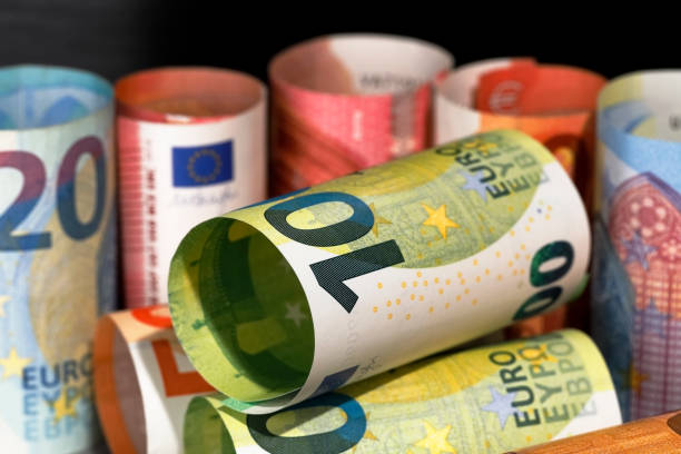 istock Rolled-up and laid-up euro banknotes 1336897665