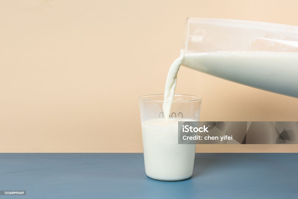 Pour Milk Into A Glass From A Large Glass Milk Bottle Stock Photo ...