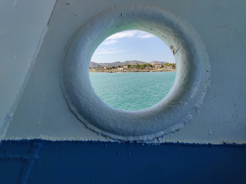 Watching the island of salamis through a boat