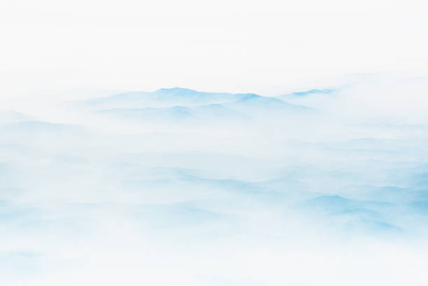 Aerial view of distant mountains layers range in morning mist. Meditation and zen landscape. stock photo