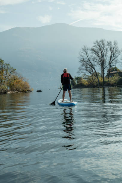 istock Man paddling on a stand up paddle board 1336904144