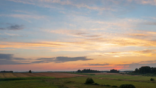 istock Colorful sunset over forest and fields aerial 1336906436