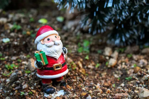 Photo of Santa Claus figurine placed on the ground.