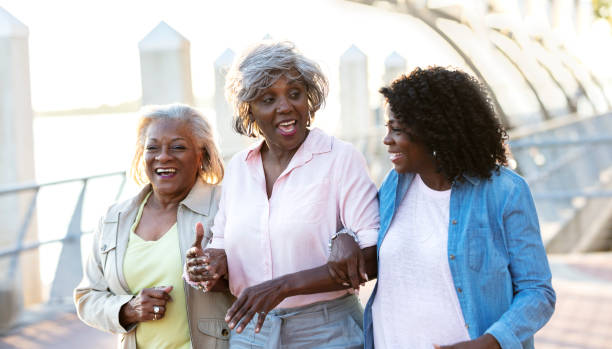 istock Three senior African-American girlfriends walk and talk 1336910077
