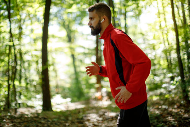 istock Young athletic man trail running in the forest 1336911019