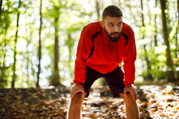 istock Portrait of young handsome man resting while exercising in nature 1336911039