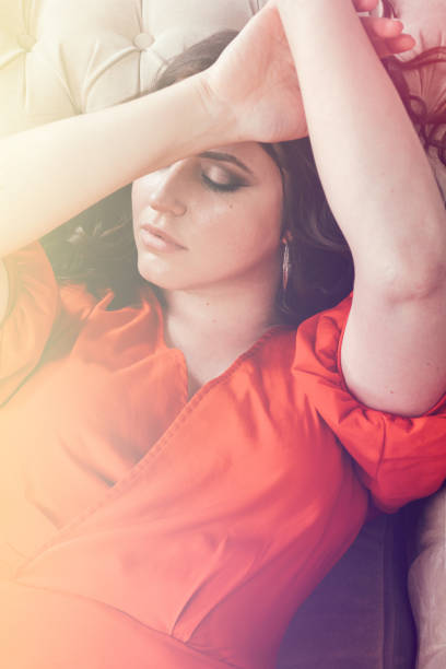 istock Beautiful woman is resting on the sofa. 1336915810