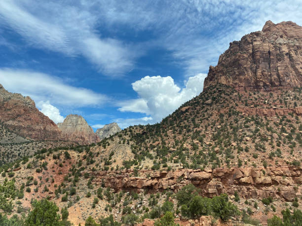 istock Cloudy sky with red mountains in Utah. 1336924866