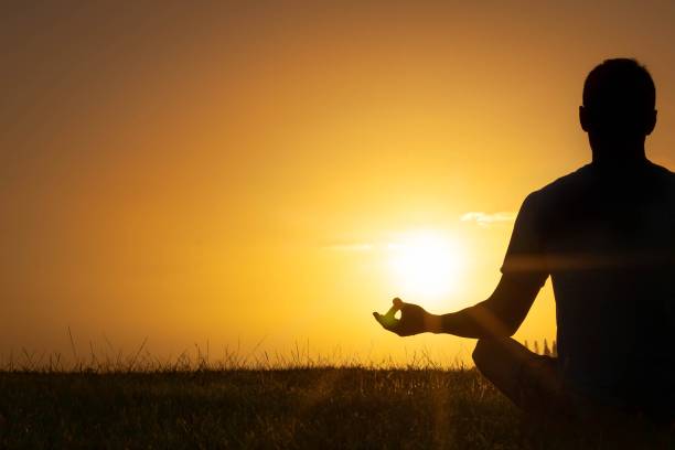 istock A man sitting outside meditating in peace. Relaxing in nature. 1336927581