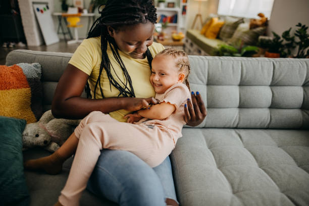 Free time at home Black woman and a white girl play at home foster care stock pictures, royalty-free photos & images