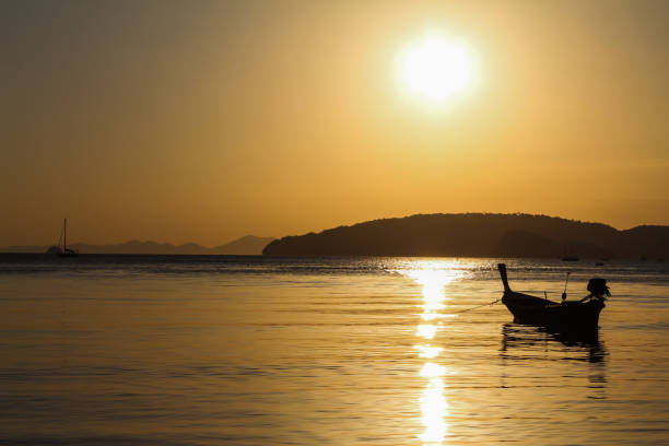 istock Sunset Landscape view from a beach with sailing boat 1336930503