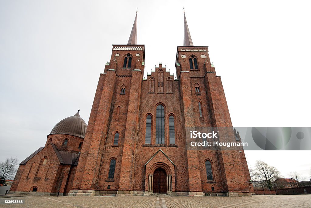 Roskilde Cathedral Roskilde Cathedral in the city of Roskilde on the Island of Zealand in eastern Denmark, was the first Gothic cathedral to be built of brick and its construction encouraged the spread of this Brick Gothic style throughout Northern Europe. It was built during the 12th and 13th centuries, and incorporates both Gothic and Romanesque architectural features in its design. The cathedral's twin spires dominate the skyline of the town.  Roskilde Stock Photo