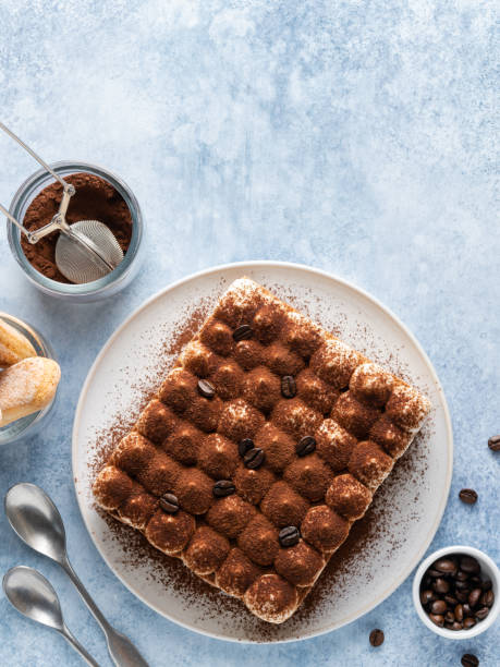 Tiramisu cake. Cocoa powder and coffee beans decoration. Copy space. Table top view.