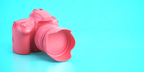 istock Pink DSLR photo camera on cyan background. 1336937056