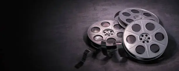 Photo of Film reels on black background. Movie, video and cinema prodaction and edition concept.
