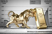 Golden ingot and bull on graph.  Bull market trend in gold.