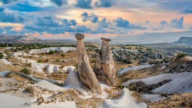 Fairy chimney rock formations of Cappadocia landscape under dramatic clouds, Nevsehir, Turkey