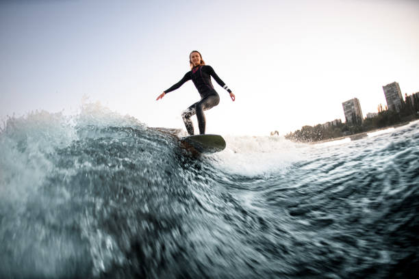 istock active female wakesurfer balanced on the board on river wave 1336950287