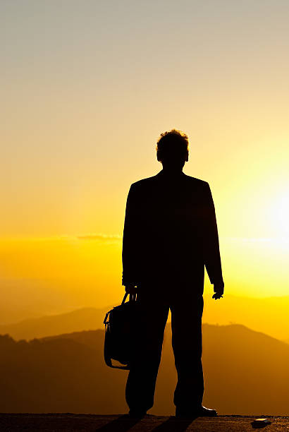 istock Silhouette of single mature man smoking at dusk 133695074