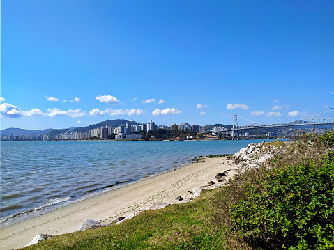 Seascape of the beautiful Florianóplis, made on the shore of the Estreito, on the continental side, with a calm and tranquil sea. Photo taken in Florianópolis, Santa Catarina, Brazil on 08/08/2021.