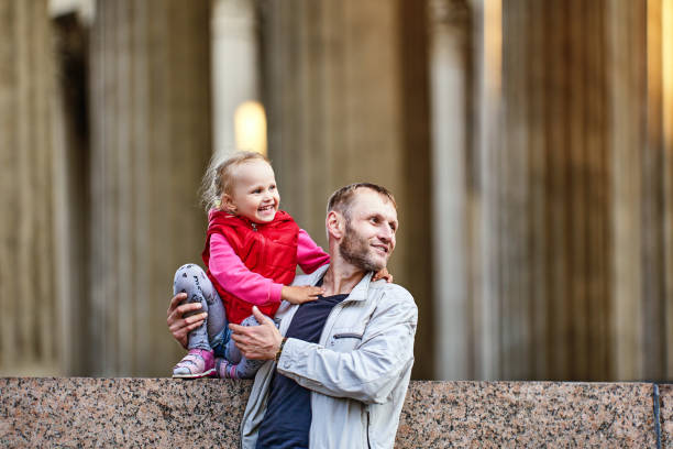 istock Father and smiling baby walks near columns. 1336953973