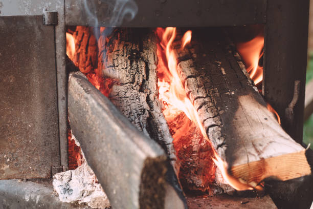 istock Open firebox of yard cauldron, with firewood burning in it 1336955395