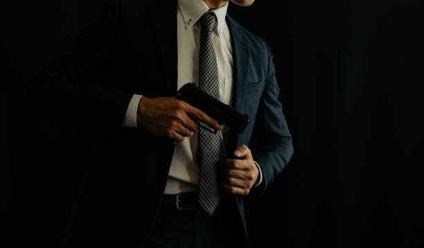 A man holding pistol A man wearing suits and holding semi-automatic pistol manhunt law enforcement stock pictures, royalty-free photos & images