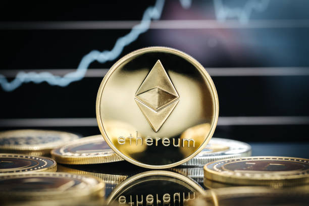 Ethereum cryptocurrency, physical coin close-up, in front of a price chart Ethereum cryptocurrency, physical coin close-up, in front of a price chart ethereum stock pictures, royalty-free photos & images