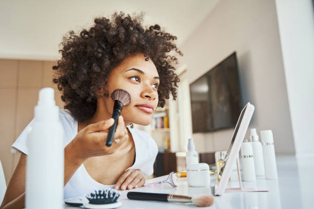 istock Calm pensive young woman making herself up 1336958415