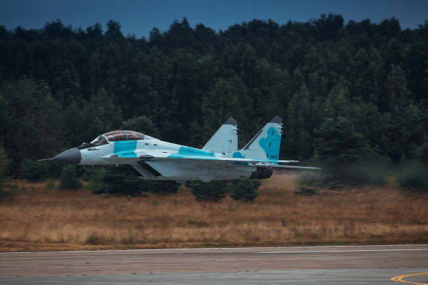 istock Jet fighter airplane fly on very high speed above runway 1336959963