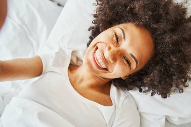 istock High-spirited smiling dark-haired female taking a selfie 1336962129