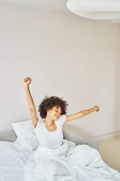 istock Pleased lady having a stretch after wake-up 1336962137