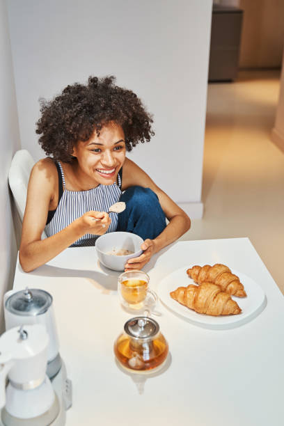 istock Cheerful attractive woman having oatmeal for breakfast 1336962139