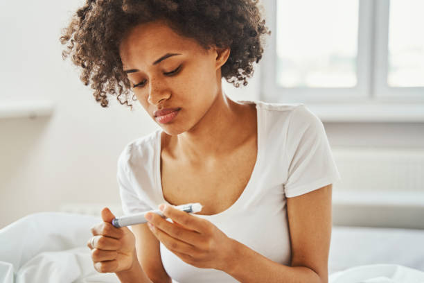 istock Female focused on examining an injection device 1336962151