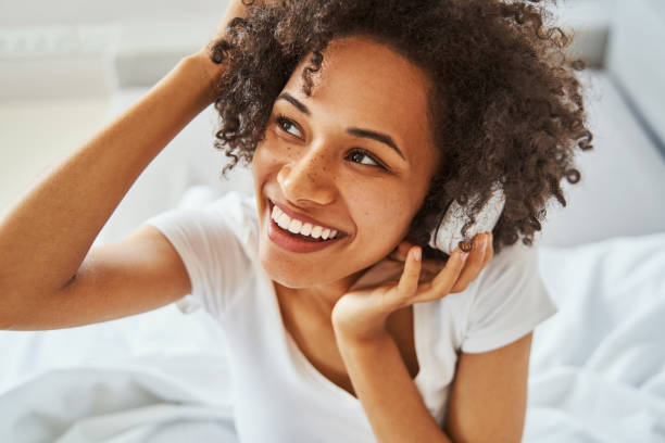 istock Joyous pretty lady in wireless headphones looking away 1336962178