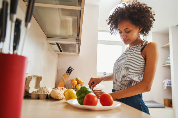 istock Serious beautiful dark-haired woman concentrated on preparing dinner 1336962185