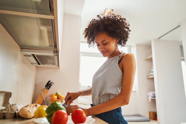 istock Attractive calm young woman making a salad 1336962191