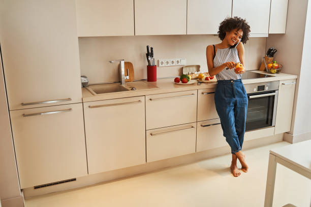 istock High-spirited woman peeling an apple during the phone call 1336962194