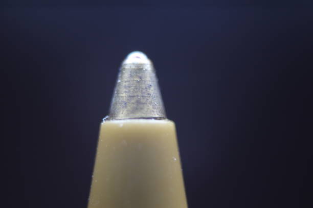 istock Macro photo of ballpoint pen tip with dark grey background. 1336962245