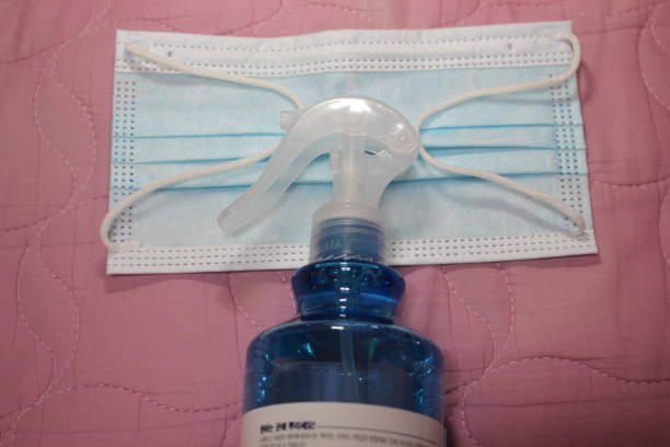 istock blue color cloth face mask with hand sanitizer bottle 1336962249
