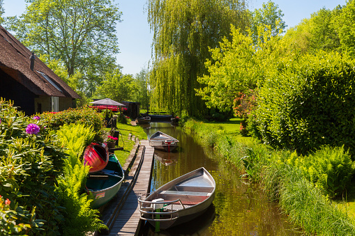 Giethoorn, Netherlands, May 30, 2021. The famous village of Giethoorn in the Netherlands with traditional dutch houses, gardens and water canals and wooden bridges is know as \
