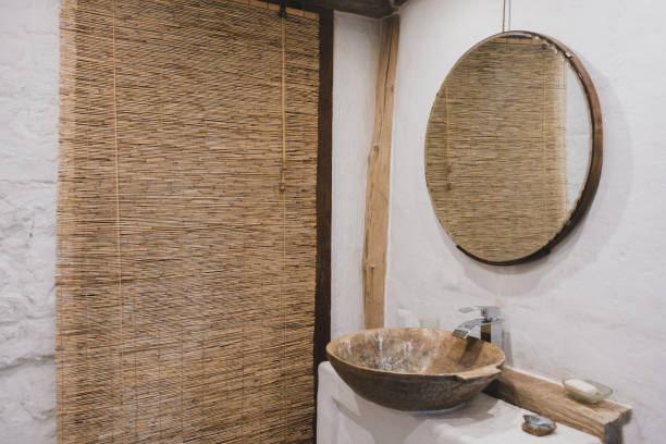 istock Loft style bathroom with washbasin and round mirror 1336969935