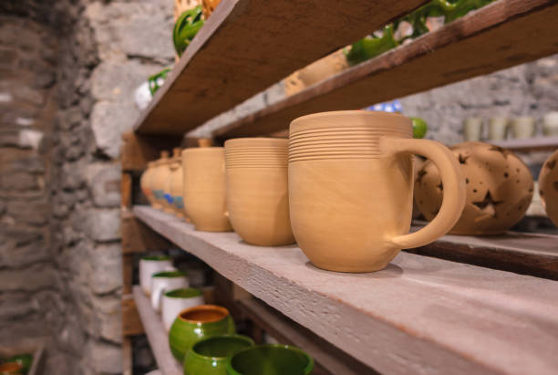 istock Clay cups stand on a shelf in a row. 1336969940