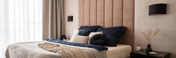 istock Fancy beige bedroom with dark details, panorama 1336969985