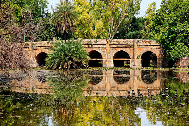 Athpula Stone Bridge Reflection  Lodi Gardens New Delhi India Athpula Eight Piers Stone Bridge Reflection Lodi Gardens New Delhi India 17th Century Bridge lodi gardens stock pictures, royalty-free photos & images