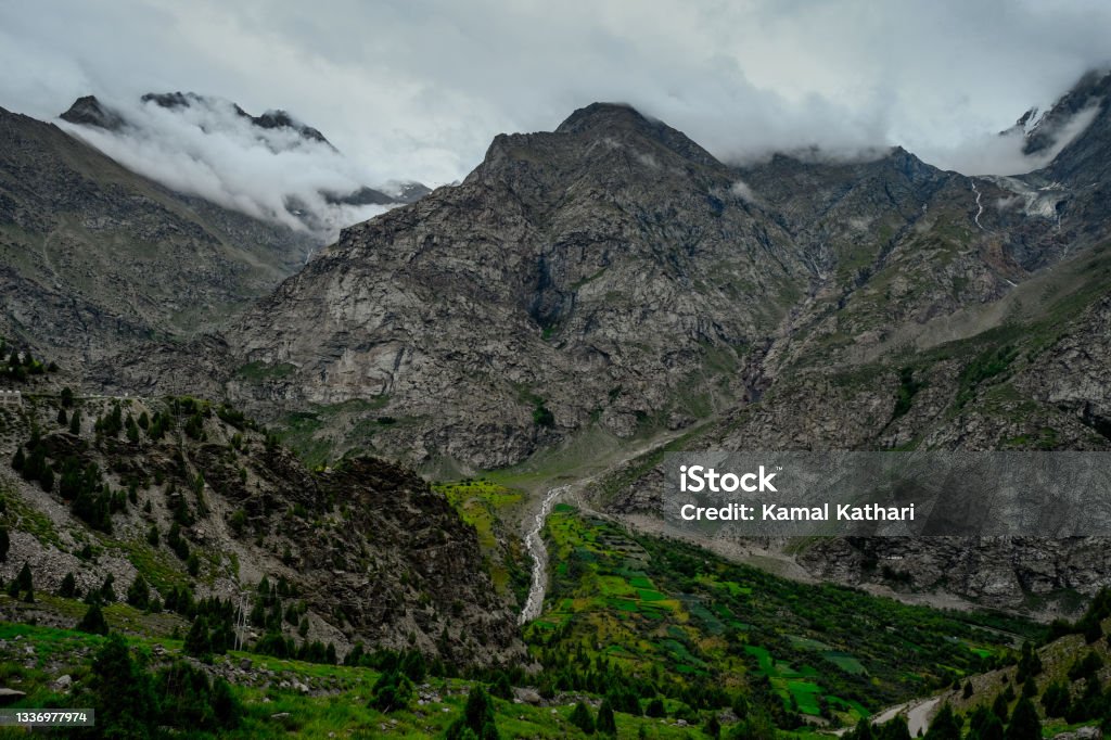 High Himalayan landscapes spewed with vegetation in summers, overseen by barren mountains Beautiful landscapes in high Himalayas in summers Beauty In Nature Stock Photo